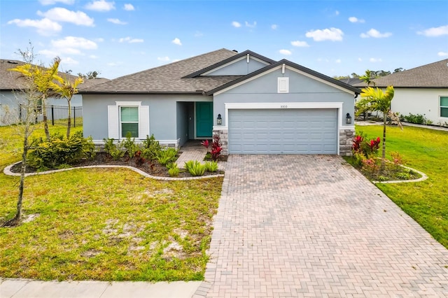 single story home with a front yard, an attached garage, stucco siding, stone siding, and decorative driveway