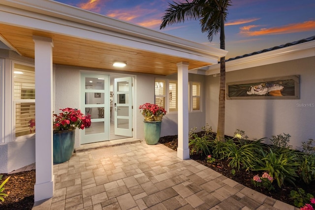 exterior entry at dusk with stucco siding