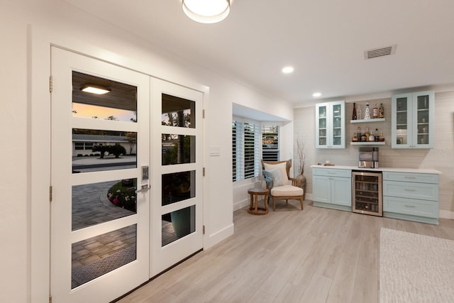 bar featuring a dry bar, beverage cooler, visible vents, light wood-style flooring, and recessed lighting