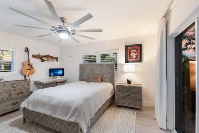 bedroom with light wood-style flooring, baseboards, and ceiling fan