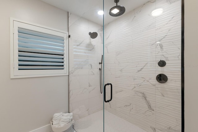 bathroom with a marble finish shower