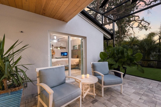 view of patio featuring glass enclosure