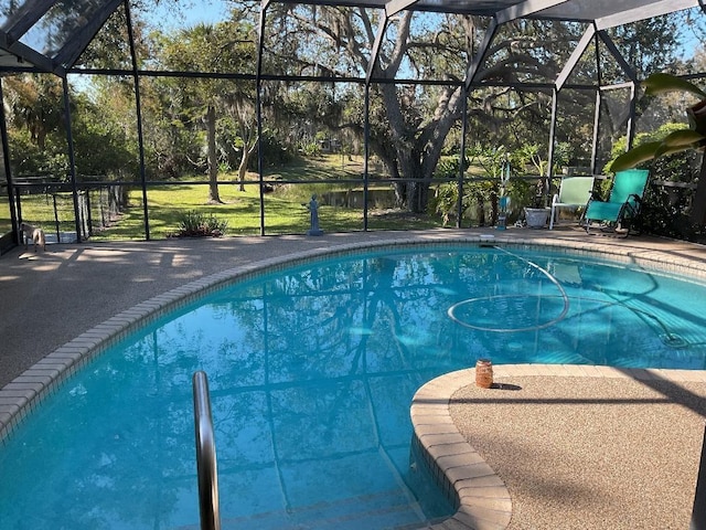 pool with a lanai and a patio