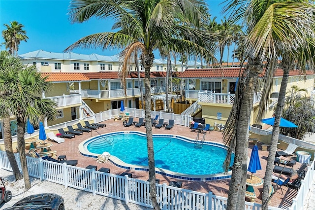 pool with a patio area, a residential view, and fence