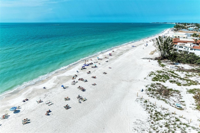 aerial view with a water view and a beach view