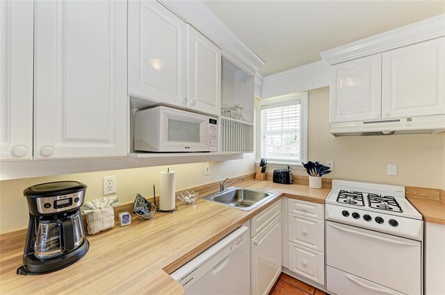 kitchen with white appliances, white cabinets, a sink, and under cabinet range hood