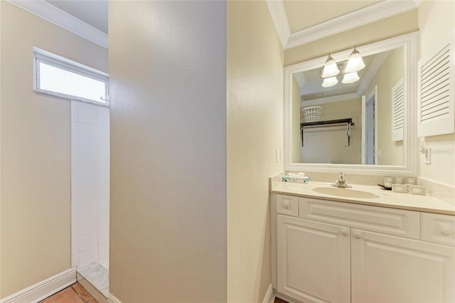 bathroom with baseboards, a tile shower, crown molding, and vanity