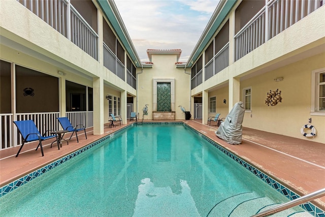 community pool with a patio area