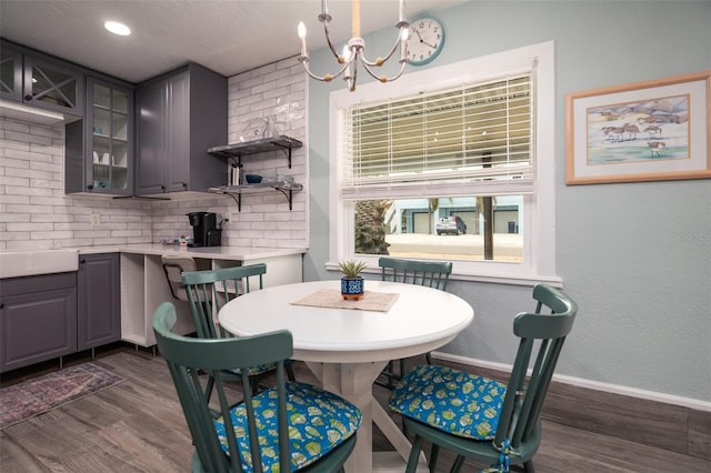 dining room featuring baseboards, dark wood finished floors, recessed lighting, a textured wall, and a chandelier