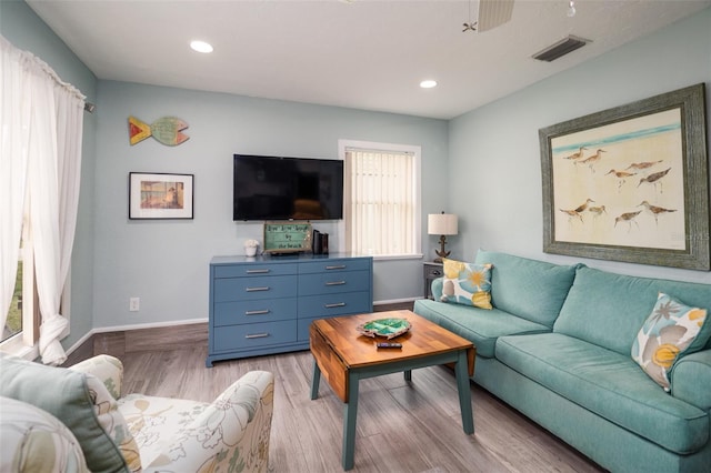 living room with light wood finished floors, visible vents, recessed lighting, and baseboards