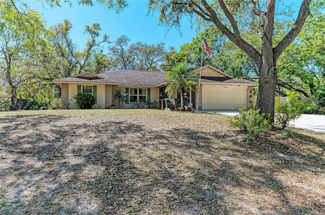 single story home featuring concrete driveway and an attached garage