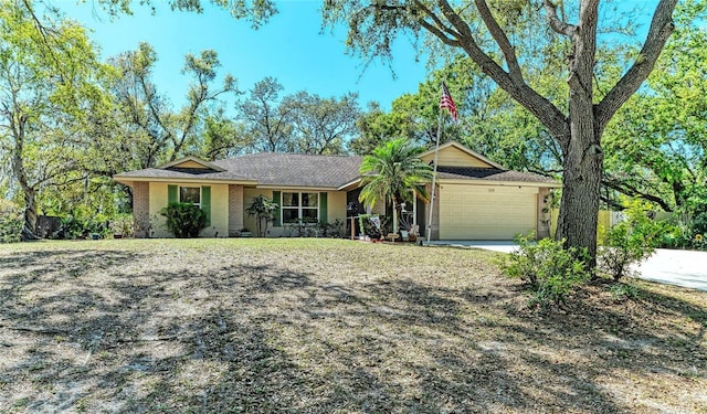 single story home featuring brick siding, concrete driveway, and an attached garage