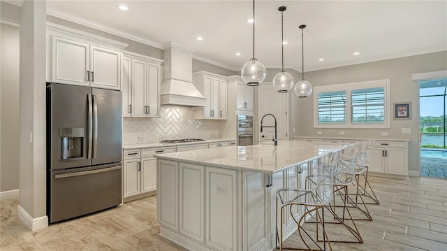 kitchen featuring custom range hood, tasteful backsplash, appliances with stainless steel finishes, white cabinets, and crown molding