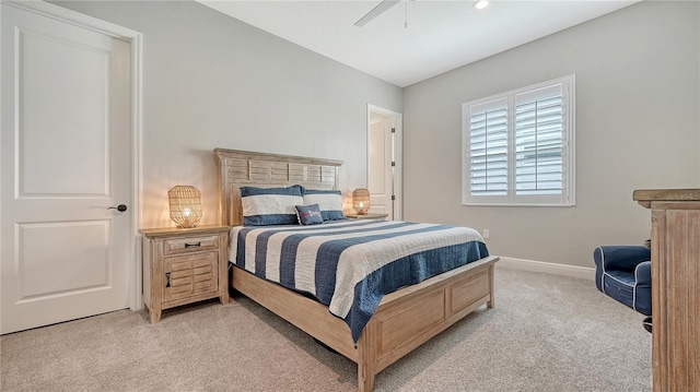 bedroom with baseboards, light carpet, and a ceiling fan