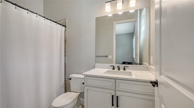 bathroom with vanity, a shower with shower curtain, and toilet