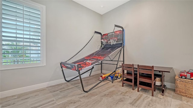 game room featuring baseboards