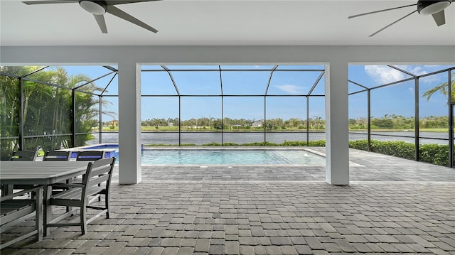 outdoor pool with a lanai, a ceiling fan, and a patio area