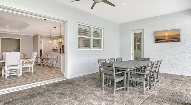 dining area with recessed lighting, a textured wall, a ceiling fan, and crown molding