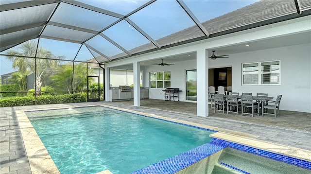 outdoor pool featuring outdoor dining space, glass enclosure, a patio, exterior kitchen, and ceiling fan