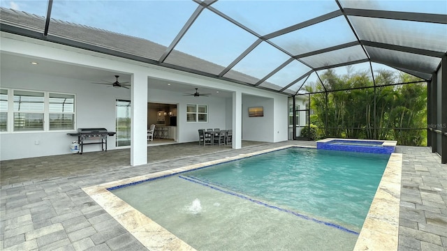 view of swimming pool with grilling area, a pool with connected hot tub, outdoor dining area, a patio area, and a ceiling fan