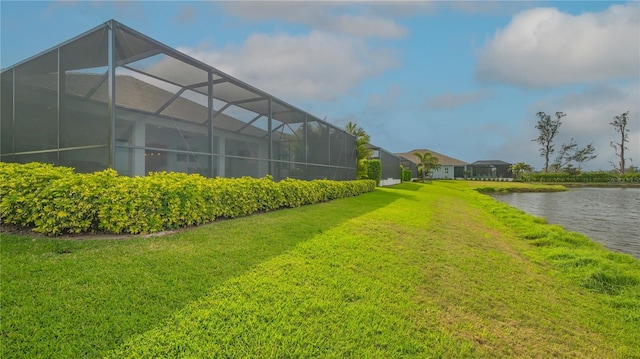 view of yard with a lanai and a water view