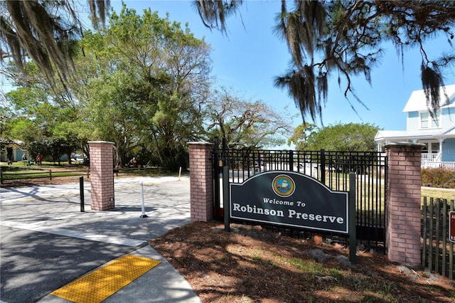 community sign featuring fence