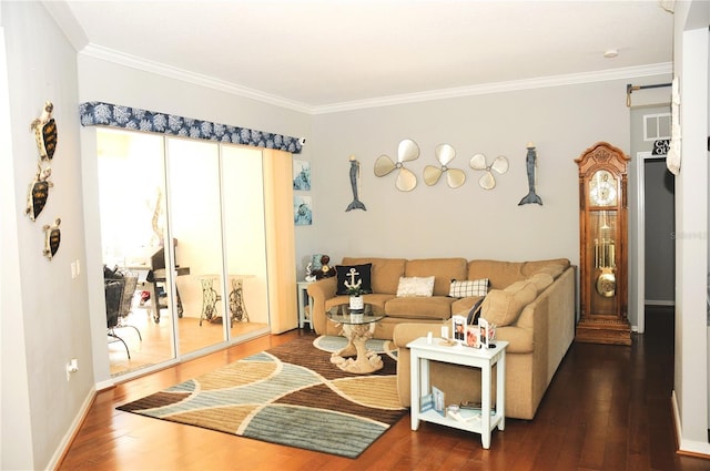 living area featuring baseboards, visible vents, wood-type flooring, and ornamental molding