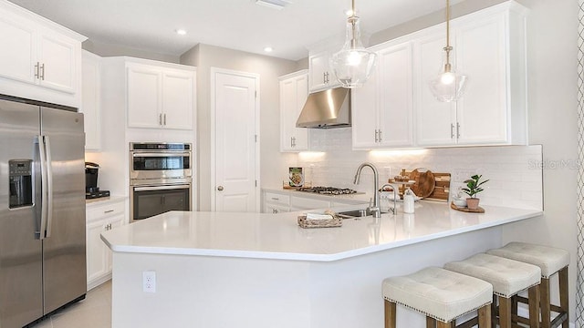 kitchen featuring appliances with stainless steel finishes, white cabinets, and under cabinet range hood