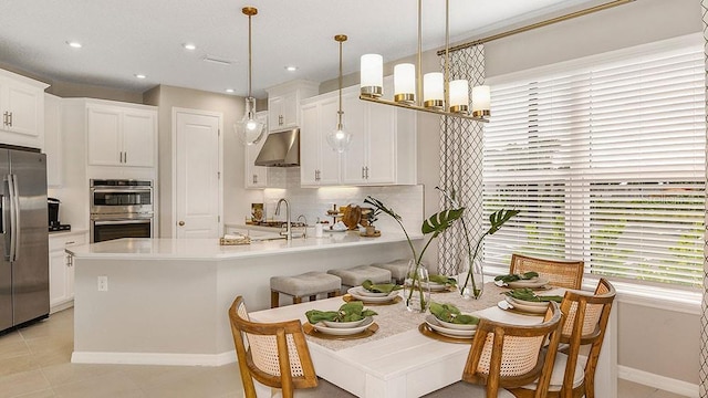 dining room featuring light tile patterned floors, recessed lighting, baseboards, and a notable chandelier