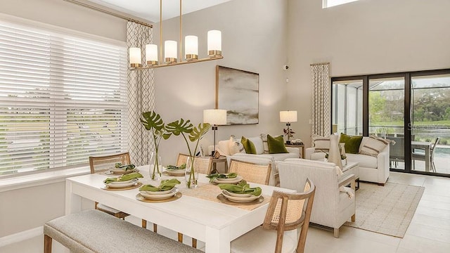 dining area with a high ceiling and a chandelier