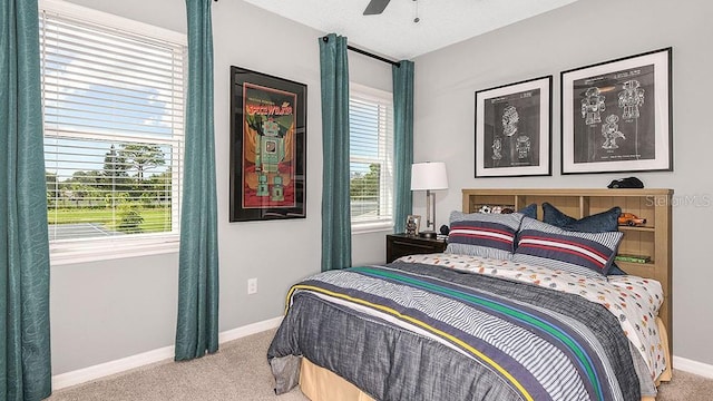 bedroom with ceiling fan, carpet, and baseboards