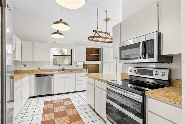 kitchen featuring appliances with stainless steel finishes, backsplash, a sink, and light countertops