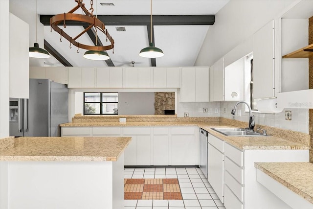 kitchen with tasteful backsplash, a peninsula, stainless steel appliances, light countertops, and a sink