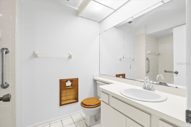 bathroom with toilet, vanity, a shower, and tile patterned floors