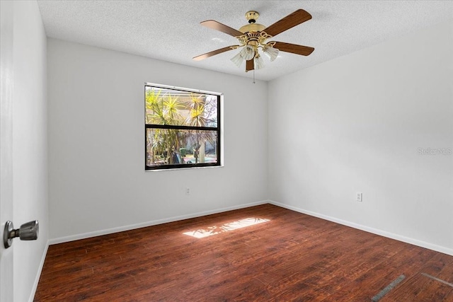 empty room featuring ceiling fan, a textured ceiling, baseboards, and wood finished floors