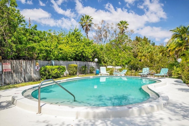 pool featuring a patio and fence