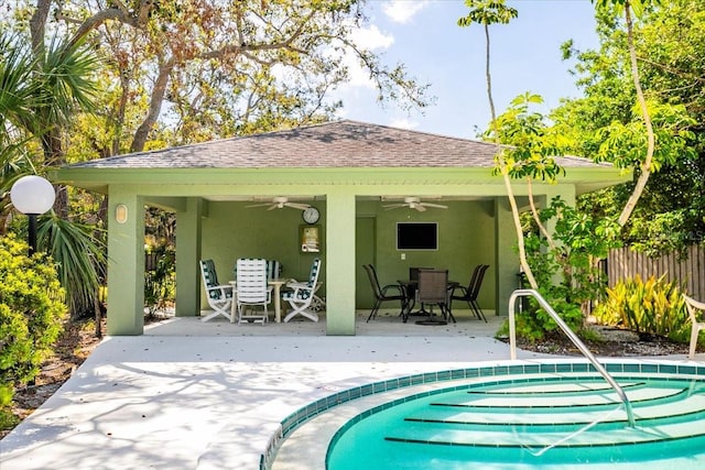 back of house featuring a patio, outdoor dining area, fence, a ceiling fan, and stucco siding