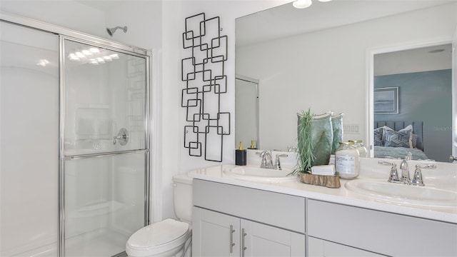 ensuite bathroom featuring double vanity, a shower stall, a sink, and ensuite bathroom