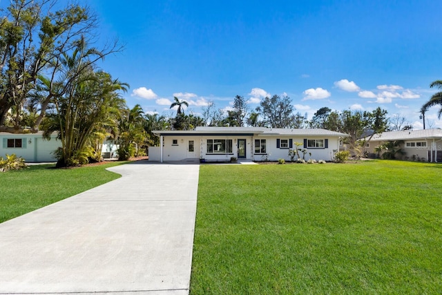 single story home featuring driveway and a front lawn