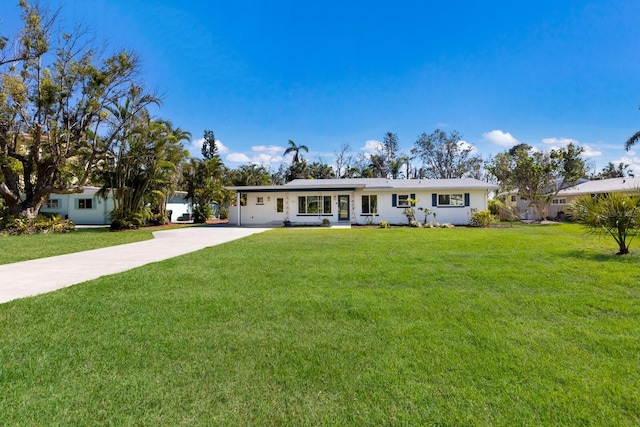 single story home with concrete driveway and a front yard