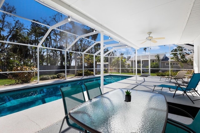 view of pool featuring a patio area, a lanai, outdoor dining area, and ceiling fan