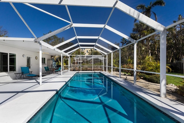 outdoor pool featuring a lanai and a patio area