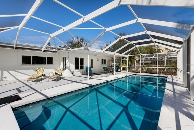 outdoor pool with a lanai and a patio area