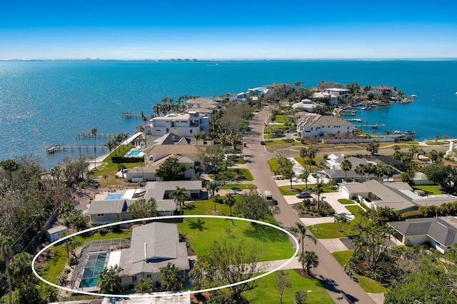 drone / aerial view featuring a residential view and a water view