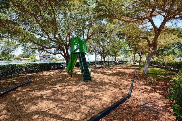 view of home's community with playground community and a water view