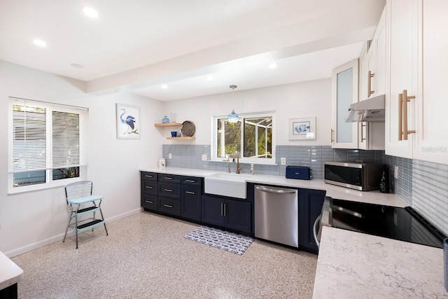 426 S Shore Dr, Sarasota, FL 34234 - kitchen featuring stainless steel appliances, under cabinet range hood, a sink, and white cabinetry