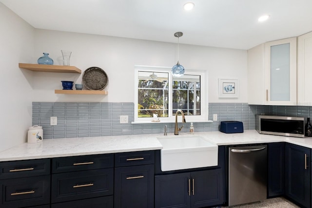 426 S Shore Dr, Sarasota, FL 34234 - kitchen featuring light stone counters, tasteful backsplash, open shelves, a sink, and stainless steel appliances