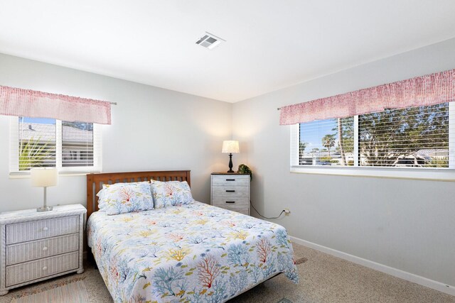 426 S Shore Dr, Sarasota, FL 34234 - bedroom with carpet floors, visible vents, baseboards, and multiple windows