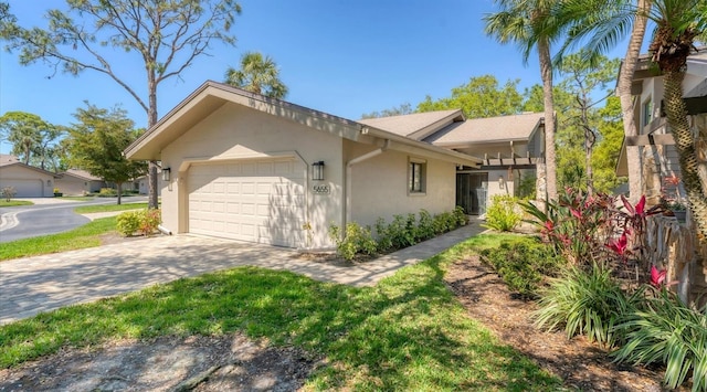 view of property exterior featuring stucco siding, driveway, and an attached garage