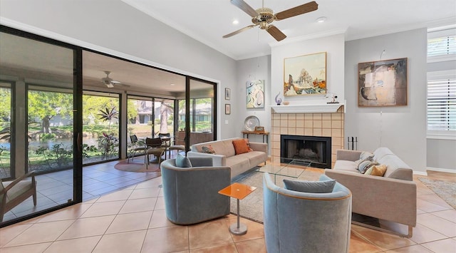 tiled living area with ornamental molding, a ceiling fan, recessed lighting, a fireplace, and baseboards